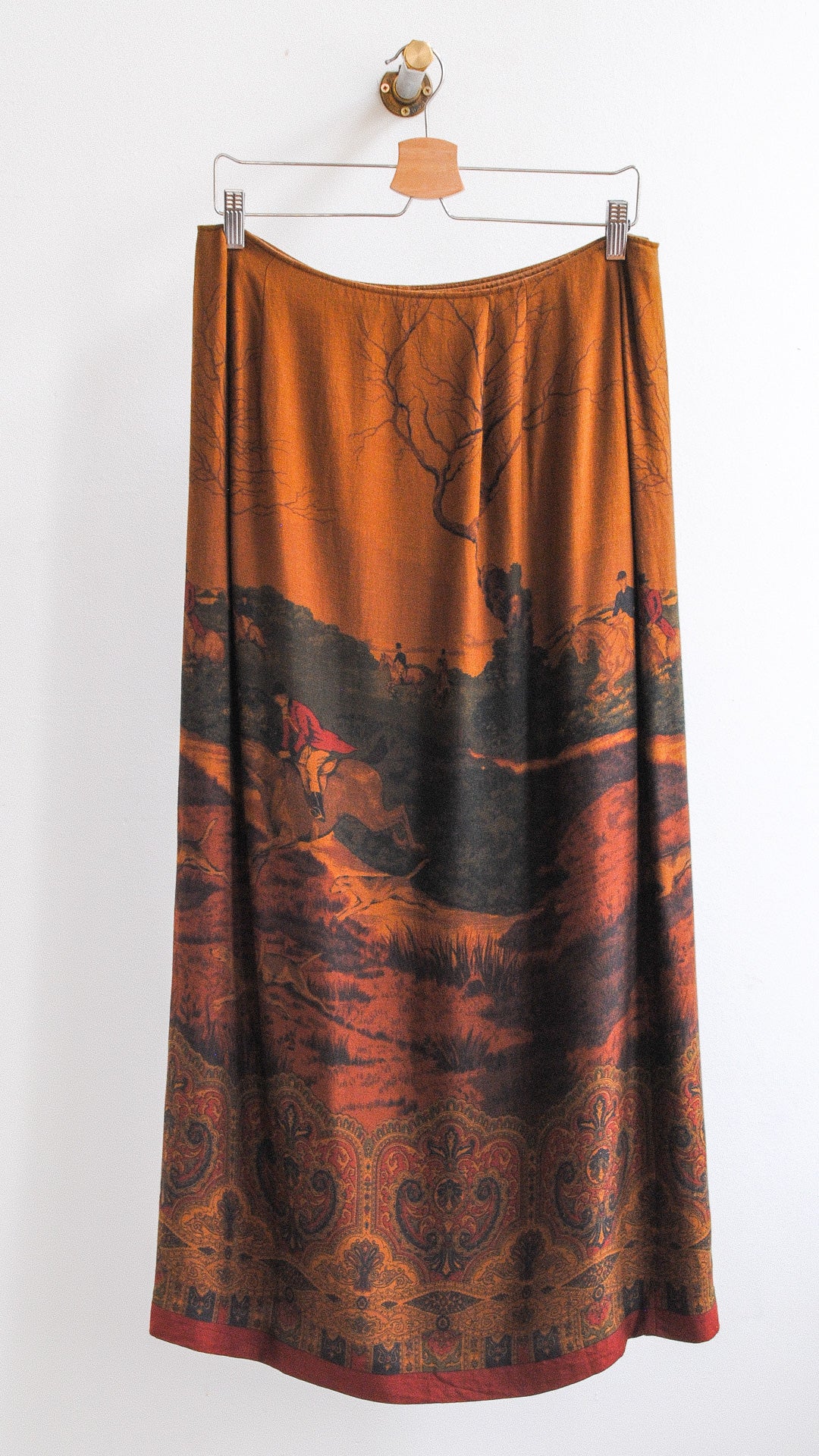 back of long brown yves saint laurent vintage skirt with horseback riding imagery in nature