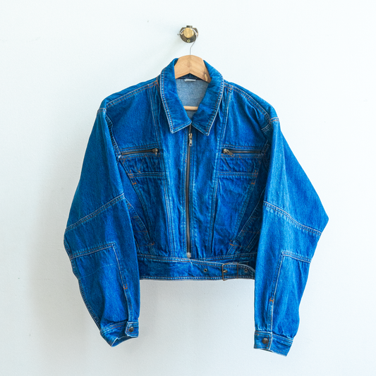 cropped dark blue nineties jeans jacket in biker style with a zipper two chest pockets and a rough overall look on a hanger